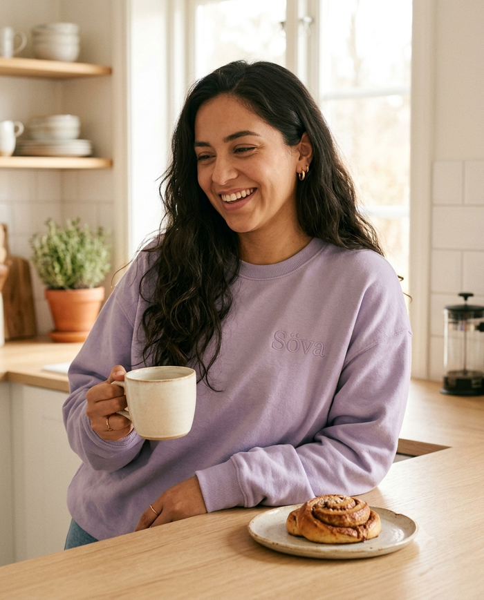Fika Crewneck Sweatshirt in Lavendel — coffee and cinnamon bun in a bright kitchen